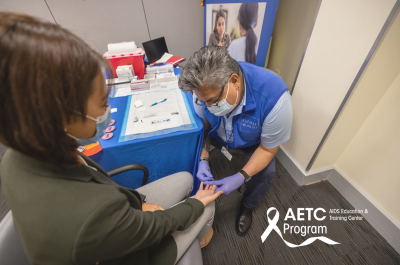 image of clinician taking blood from another clinician
